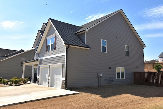 190 Colfax Dr, Boiling Springs, SC 29316 - back of house featuring a garage, driveway, a shingled roof, and stone siding
