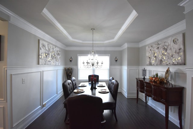 190 Colfax Dr, Boiling Springs, SC 29316 - dining space with dark wood-type flooring, a chandelier, a decorative wall, a raised ceiling, and a wainscoted wall