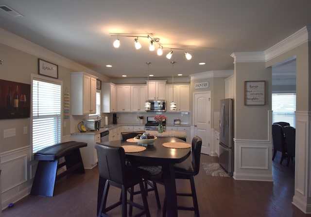 190 Colfax Dr, Boiling Springs, SC 29316 - dining space with ornamental molding, a decorative wall, a wainscoted wall, dark wood-style flooring, and recessed lighting