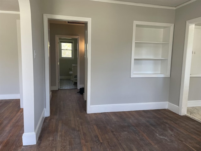 126 White Oak Rd, Spartanburg, SC 29301 - empty room with dark wood-style flooring, ornamental molding, and built in shelves