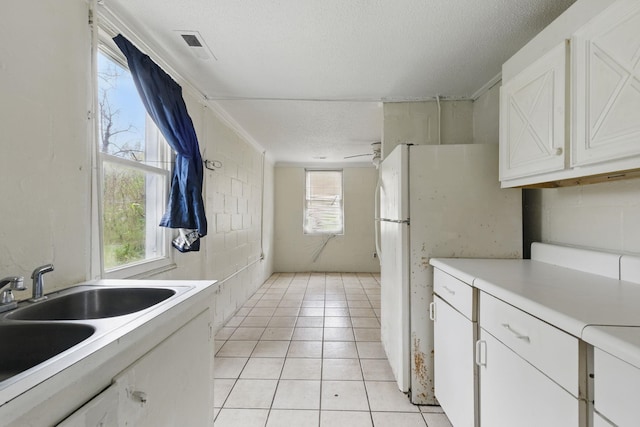 207 Streamside Dr, Chesnee, SC 29323 - kitchen featuring light countertops, white cabinetry, light tile patterned floors, a textured ceiling, and freestanding refrigerator