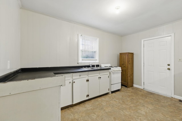 207 Streamside Dr, Chesnee, SC 29323 - kitchen with white electric range, light flooring, dark countertops, white cabinetry, and crown molding