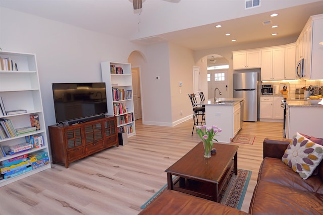 2054 Lachaise Ln, Moore, SC 29369 - living room with arched walkways, light wood-style floors, ceiling fan, and recessed lighting