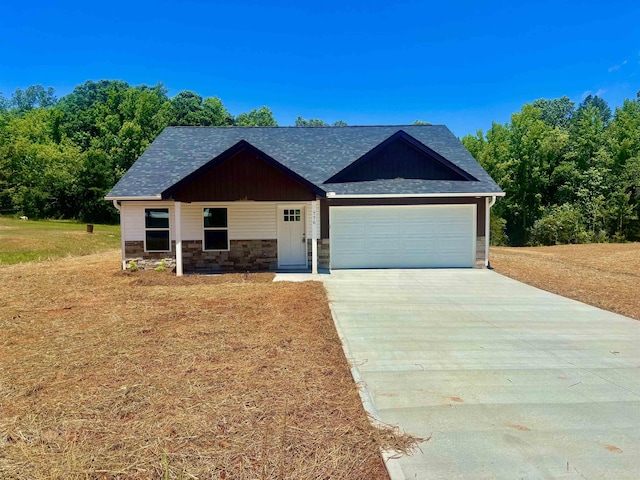 776 Darwin Rd, Gaffney, SC 29340 - view of front of property with concrete driveway, an attached garage, stone siding, a shingled roof, and a front lawn