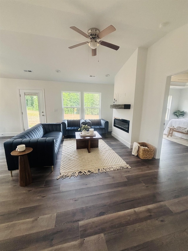 776 Darwin Rd, Gaffney, SC 29340 - living area with healthy amount of natural light, a glass covered fireplace, dark wood-style flooring, ceiling fan, and vaulted ceiling
