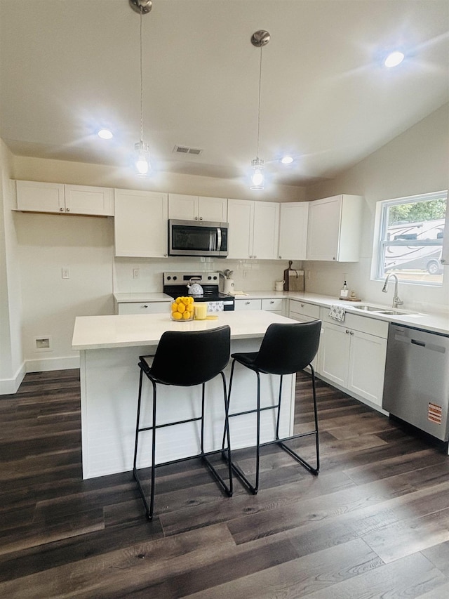 776 Darwin Rd, Gaffney, SC 29340 - kitchen featuring stainless steel appliances, dark wood finished floors, recessed lighting, a kitchen island, and white cabinetry