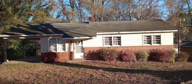 109 Shoally, Boiling Springs, SC 29316 - view of front of house featuring brick siding, a chimney, and a carport