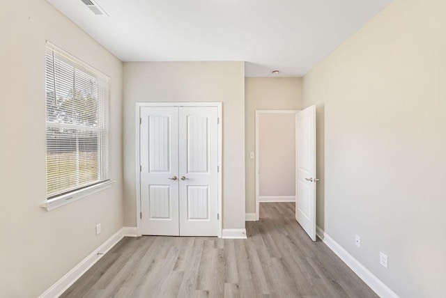 119 N Moore St, Duncan, SC 29334 - unfurnished bedroom with light wood finished floors and a closet