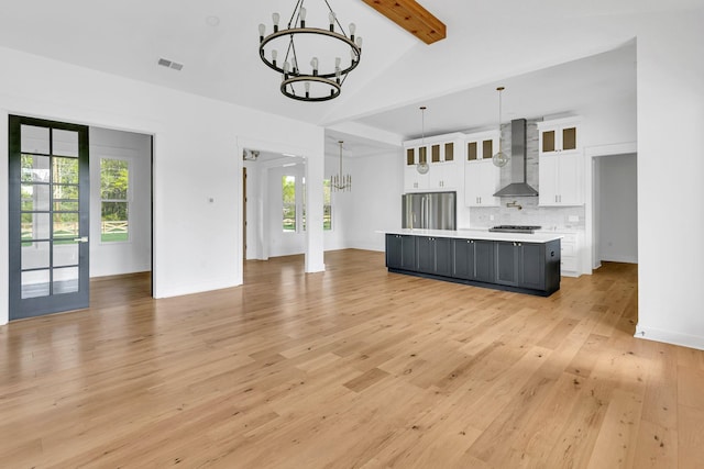 164 Triangle Pine Rd, Fountain Inn, SC 29644 - unfurnished living room featuring a chandelier, light wood-style floors, and healthy amount of natural light