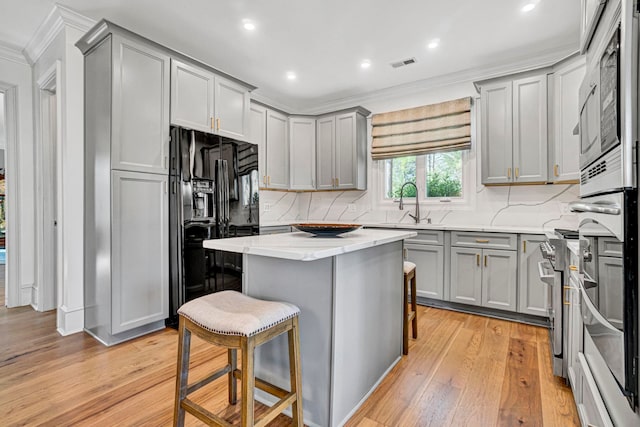 10 Torrey Pines Ct, Spartanburg, SC 29306 - kitchen featuring gray cabinetry, black fridge with ice dispenser, crown molding, light wood finished floors, and recessed lighting