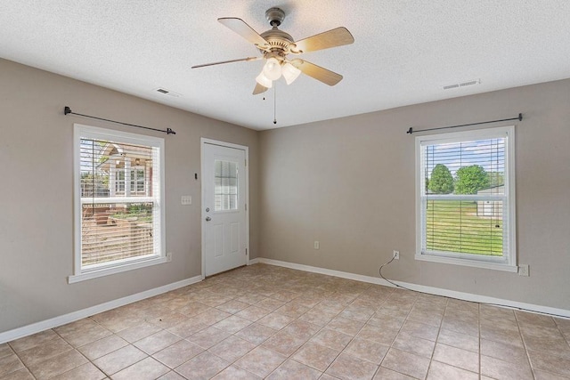 1620 Rainbow Lake Rd, Inman, SC 29349 - spare room with a textured ceiling, ceiling fan, and light tile patterned floors