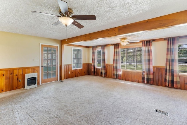 1620 Rainbow Lake Rd, Inman, SC 29349 - unfurnished living room with heating unit, wainscoting, a textured ceiling, wooden walls, and a ceiling fan