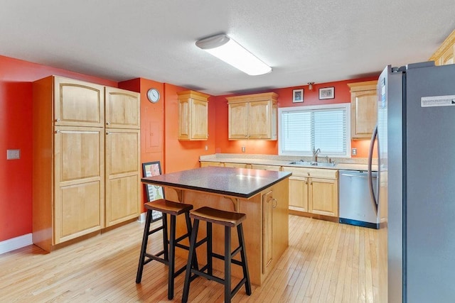 1620 Rainbow Lake Rd, Inman, SC 29349 - kitchen with stainless steel appliances, light brown cabinets, light wood finished floors, a breakfast bar area, and a kitchen island
