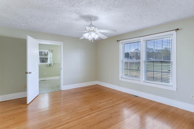 1620 Rainbow Lake Rd, Inman, SC 29349 - spare room with light wood-style floors, a textured ceiling, and ceiling fan