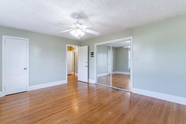 1620 Rainbow Lake Rd, Inman, SC 29349 - unfurnished bedroom with light wood-style floors, a closet, a ceiling fan, and a textured ceiling