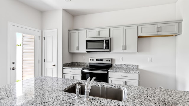 108 Sunriff Ct, Greer, SC 29651 - kitchen featuring stainless steel microwave, electric stove, light stone counters, and gray cabinets