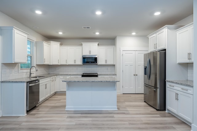 832 Redmill Ln, Duncan, SC 29334 - kitchen with stainless steel appliances, white cabinets, a center island, tasteful backsplash, and recessed lighting
