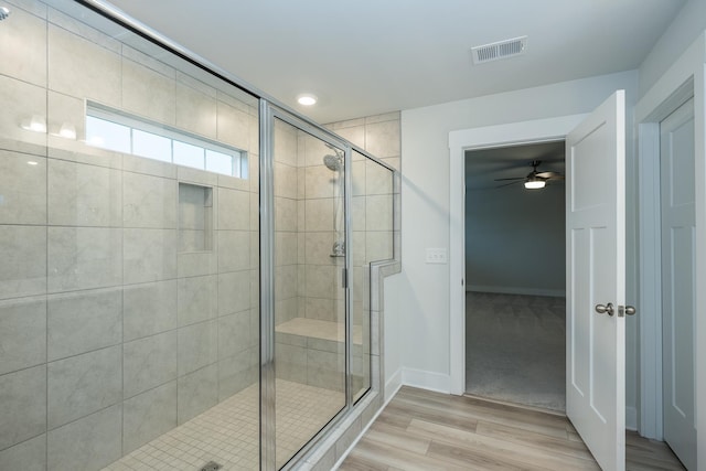 832 Redmill Ln, Duncan, SC 29334 - bathroom featuring a stall shower, wood finished floors, and a ceiling fan