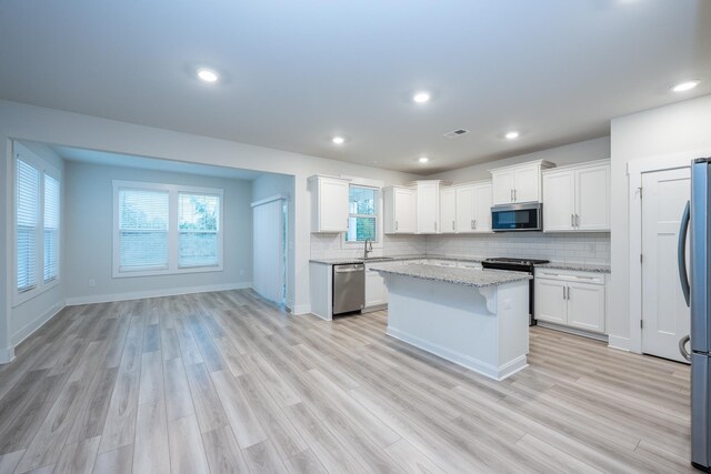 832 Redmill Ln, Duncan, SC 29334 - kitchen featuring stainless steel appliances, a center island, decorative backsplash, white cabinetry, and recessed lighting