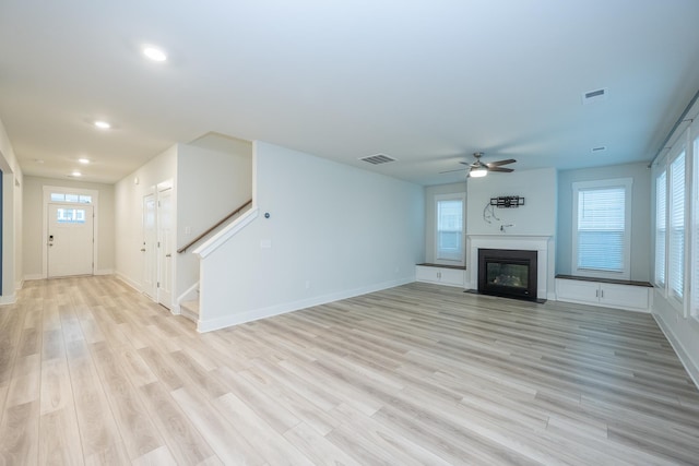 832 Redmill Ln, Duncan, SC 29334 - unfurnished living room with a ceiling fan, recessed lighting, light wood-style flooring, stairs, and a fireplace with flush hearth