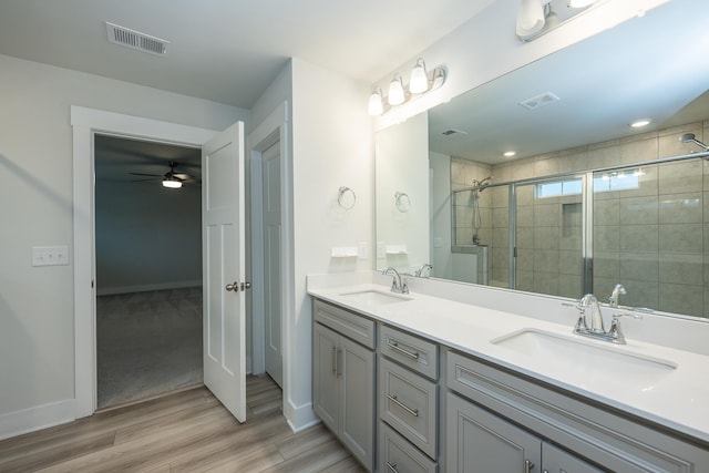 832 Redmill Ln, Duncan, SC 29334 - full bathroom with wood finished floors, double vanity, a shower stall, and ceiling fan