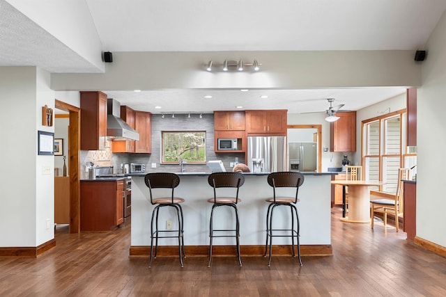 116 Dorothy Ln, Pickens, SC 29671 - kitchen with appliances with stainless steel finishes, wall chimney range hood, a breakfast bar, dark wood finished floors, and recessed lighting