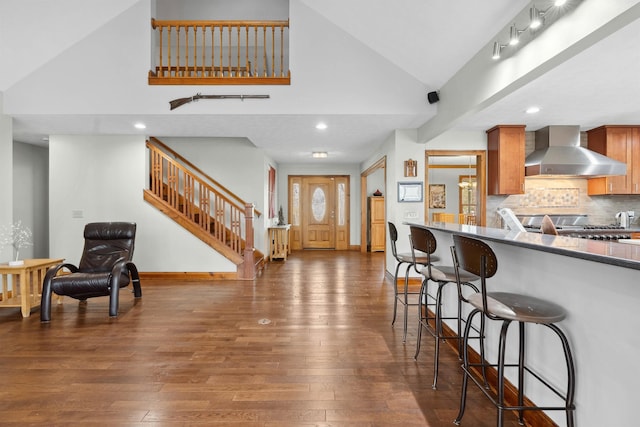 116 Dorothy Ln, Pickens, SC 29671 - kitchen featuring wall chimney range hood, wood-type flooring, a kitchen bar, high vaulted ceiling, and recessed lighting
