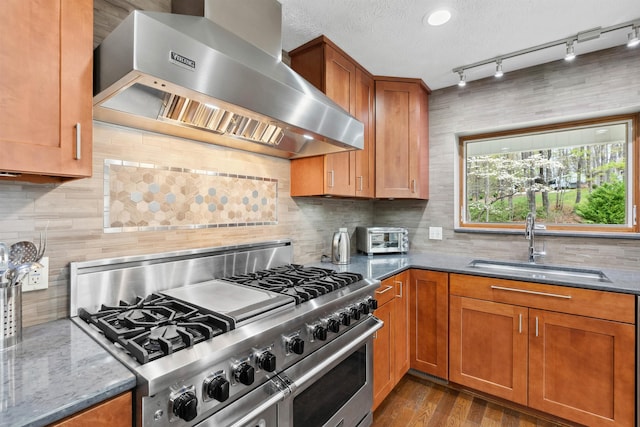 116 Dorothy Ln, Pickens, SC 29671 - kitchen featuring high end range, wall chimney range hood, stone countertops, tasteful backsplash, and brown cabinetry