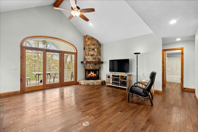 116 Dorothy Ln, Pickens, SC 29671 - living room featuring hardwood / wood-style floors, beamed ceiling, high vaulted ceiling, ceiling fan, and a stone fireplace