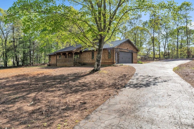 101 Owens Dr, Inman, SC 29349 - view of front of home with a metal roof, covered porch, asphalt driveway, and a standing seam roof