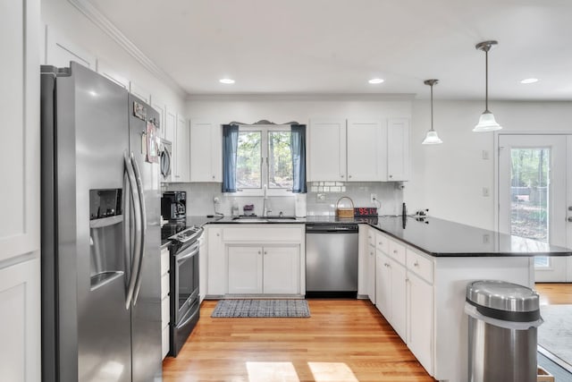 101 Owens Dr, Inman, SC 29349 - kitchen with stainless steel appliances, a peninsula, dark countertops, white cabinetry, and recessed lighting