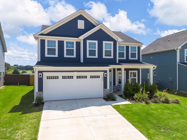 1848 Sourwood Dr, Woodruff, SC 29388 - view of front facade featuring concrete driveway, a garage, stone siding, and a porch