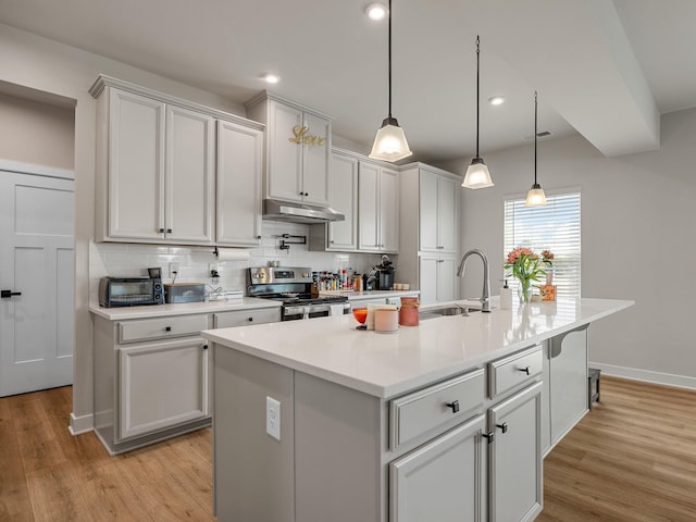 1848 Sourwood Dr, Woodruff, SC 29388 - kitchen with electric range, under cabinet range hood, backsplash, light wood-style flooring, and recessed lighting