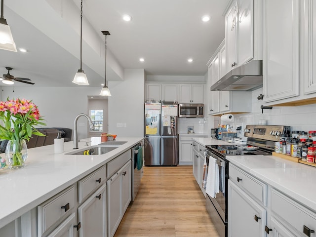 1848 Sourwood Dr, Woodruff, SC 29388 - kitchen featuring stainless steel appliances, under cabinet range hood, white cabinets, backsplash, and pendant lighting