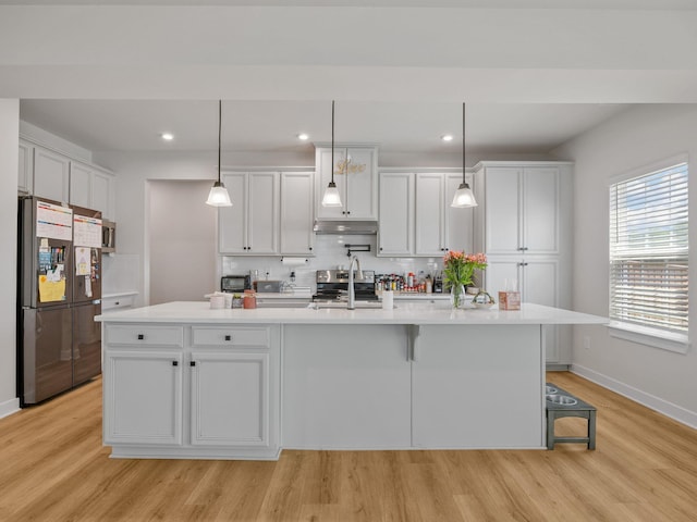 1848 Sourwood Dr, Woodruff, SC 29388 - kitchen with appliances with stainless steel finishes, light wood finished floors, backsplash, light countertops, and recessed lighting