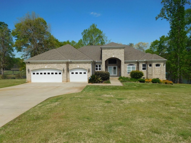 217 Aqua Cove Ct, Inman, SC 29349 - view of front of home featuring an attached garage, concrete driveway, brick siding, and a front lawn
