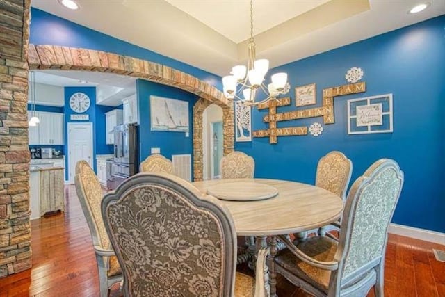 217 Aqua Cove Ct, Inman, SC 29349 - dining area with a chandelier, wood finished floors, arched walkways, a tray ceiling, and recessed lighting