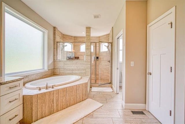 217 Aqua Cove Ct, Inman, SC 29349 - full bath featuring healthy amount of natural light, a shower stall, a bath, and vanity