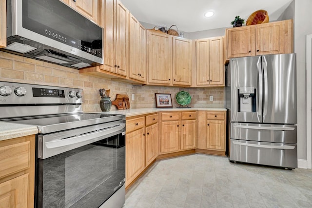 204 Lord Byron Ln, Travelers Rest, SC 29690 - kitchen with appliances with stainless steel finishes, light brown cabinetry, light countertops, tasteful backsplash, and recessed lighting