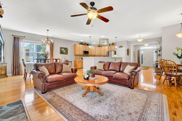 204 Lord Byron Ln, Travelers Rest, SC 29690 - living room with light wood finished floors, a ceiling fan, and a chandelier