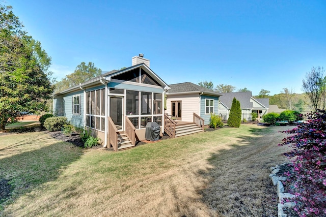 204 Lord Byron Ln, Travelers Rest, SC 29690 - rear view of house featuring a chimney, a sunroom, a lawn, and a wooden deck