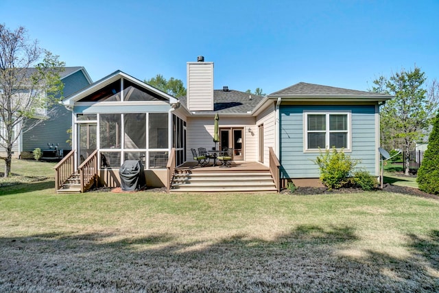 204 Lord Byron Ln, Travelers Rest, SC 29690 - back of property featuring a sunroom, a chimney, a wooden deck, a lawn, and roof with shingles