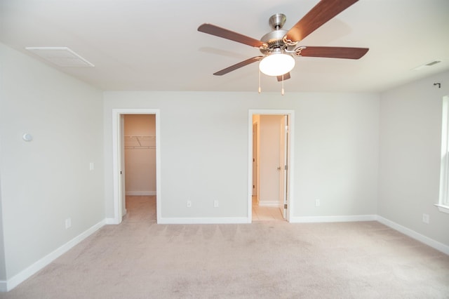 521 Preakness Run, Spartanburg, SC 29301 - unfurnished bedroom featuring a walk in closet, light colored carpet, a closet, a ceiling fan, and ensuite bath