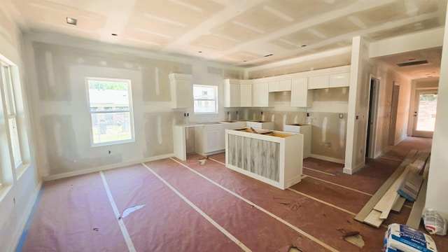 10 Bobo St, Inman, SC 29349 - kitchen with a center island and white cabinets