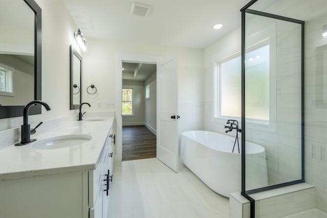 7 Campbell Mill Rd, Traveleres Rest, SC 29690 - full bath featuring a freestanding bath, double vanity, wood finished floors, and recessed lighting