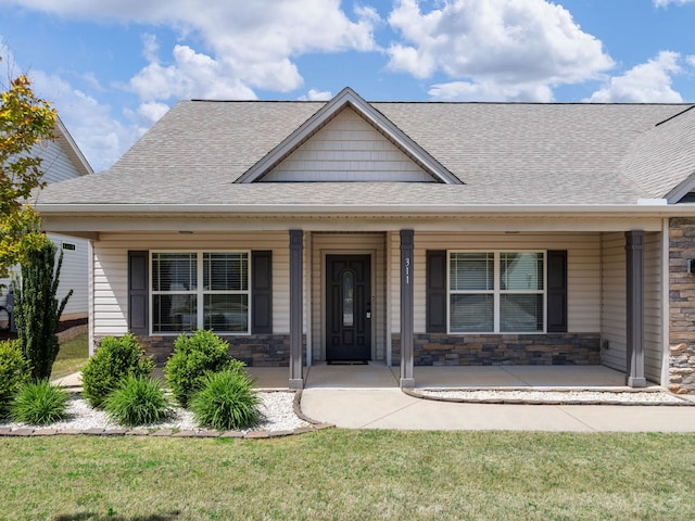311 Hayfield Ct, Boiling Springs, SC 29316 - view of front facade with stone siding, a shingled roof, a porch, and a front lawn