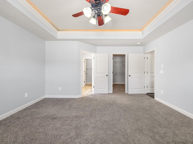 311 Hayfield Ct, Boiling Springs, SC 29316 - unfurnished bedroom with a tray ceiling, carpet flooring, ornamental molding, a spacious closet, and ceiling fan