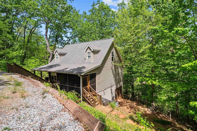 419 Hidden Hill Rd, Tryon, NC 28782 - view of front of house featuring a sunroom, roof with shingles, and an attached garage