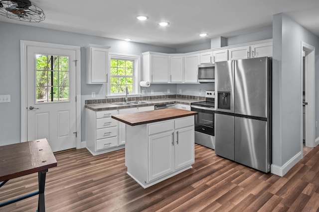 419 Hidden Hill Rd, Tryon, NC 28782 - kitchen with stainless steel appliances, butcher block counters, recessed lighting, dark wood-style flooring, and white cabinetry