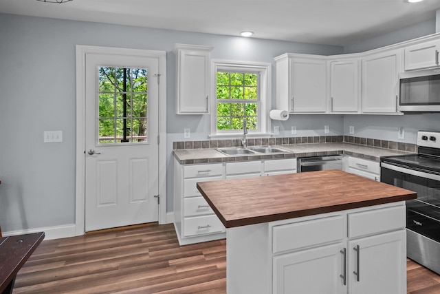 419 Hidden Hill Rd, Tryon, NC 28782 - kitchen with appliances with stainless steel finishes, wood counters, white cabinets, healthy amount of natural light, and recessed lighting
